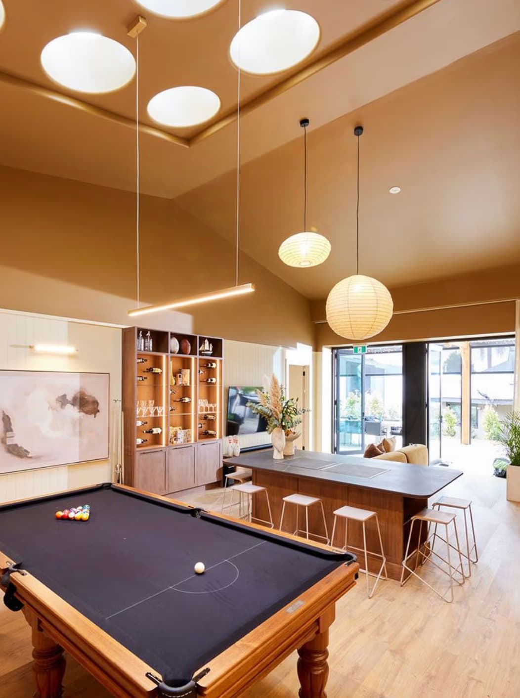 The Mayfair Residency clubhouse lounge with a pool table and bar counter